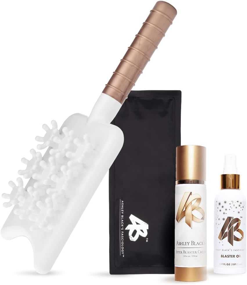 Anti-cellulite kit with massage tool, blaster oil, and cleanser bottle on display.