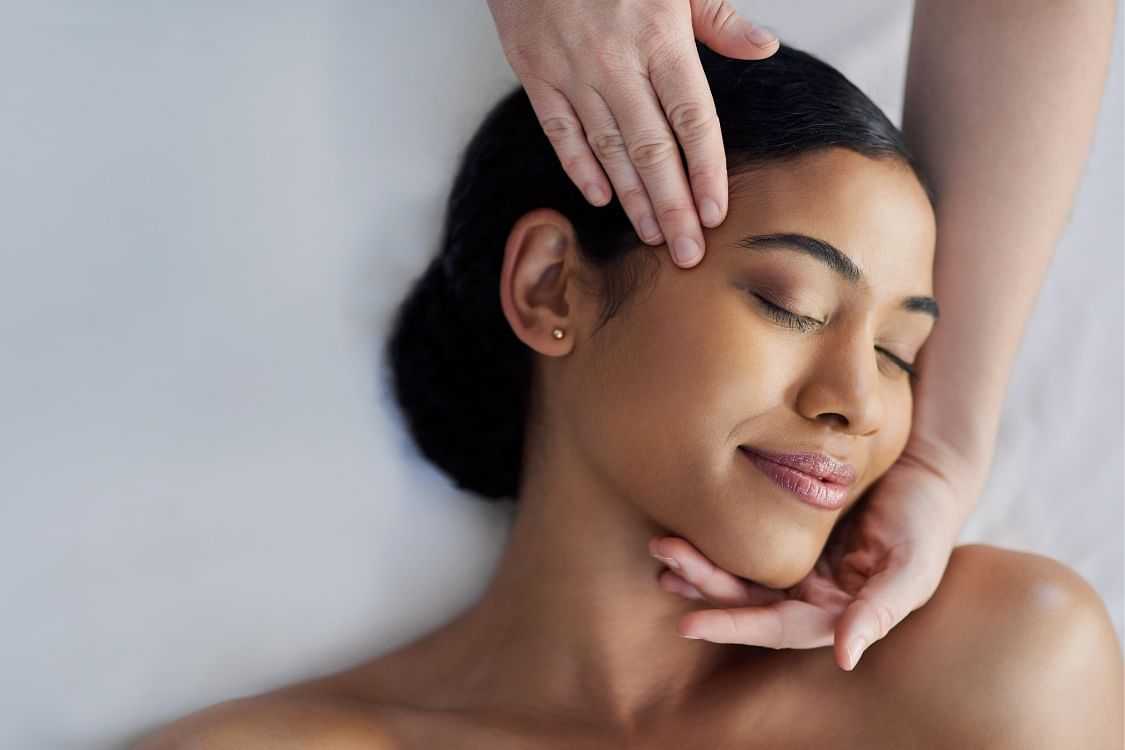 Woman receiving a relaxing facial massage.